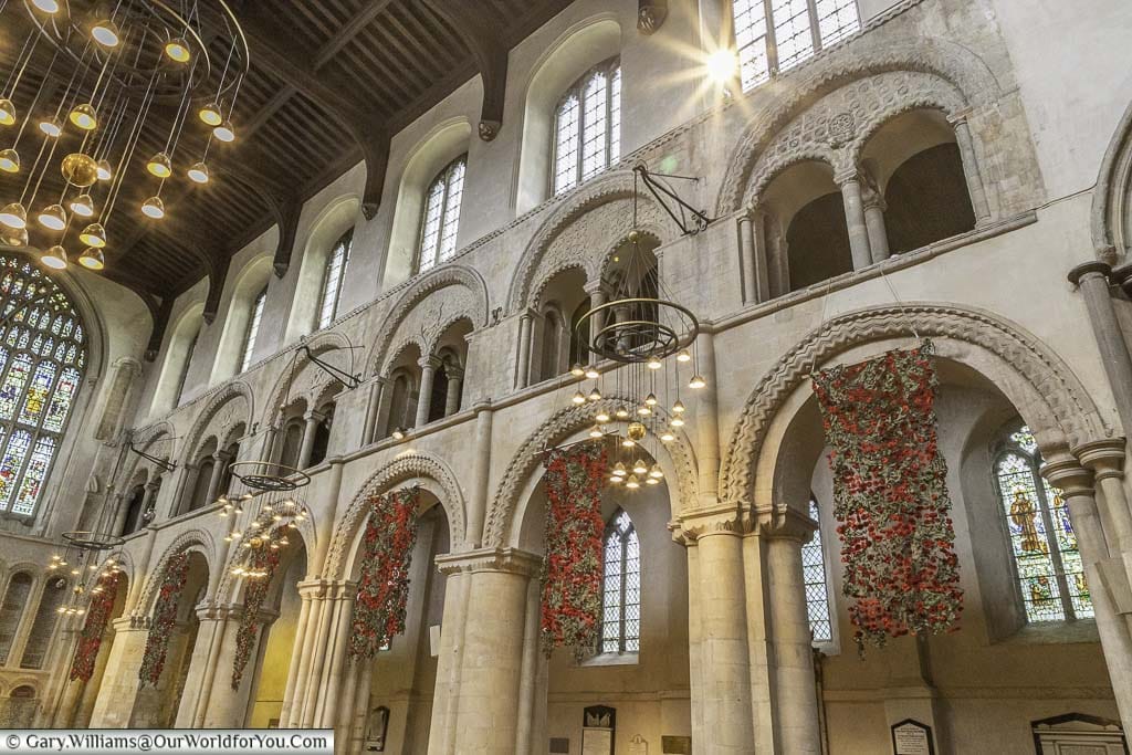 Knitted poppies hung from the arches of the nave of rochester cathedral in kent