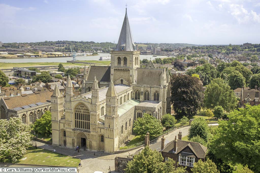Looking down on Rochester cathedral from Rochester Castle with River Medway meandering through the landscape in the background.