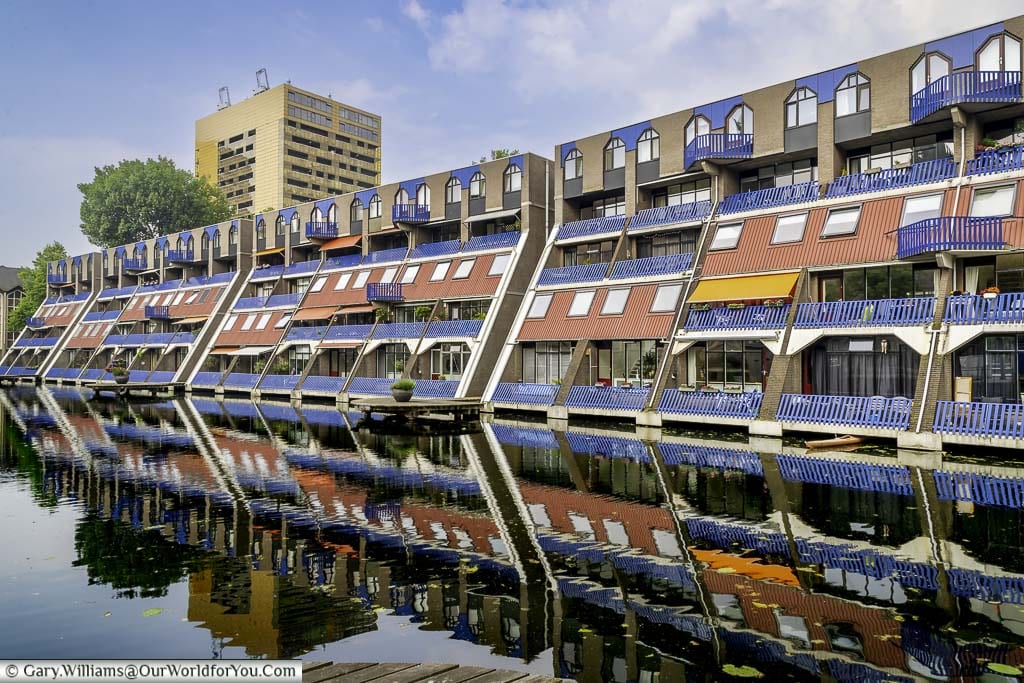 A colourful three-storey 1960s apartment block next to a canal in central rotterdam in the netherlands