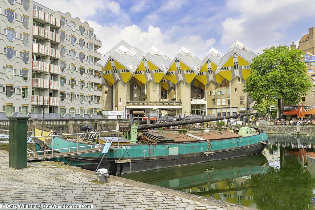 A dutch barge in the old harbour of rotterdam in front of the iconic cube houses