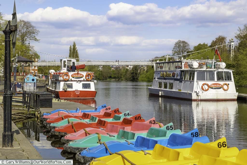 Pedalos and pleasure craft on the river dee alongside the groves in chester