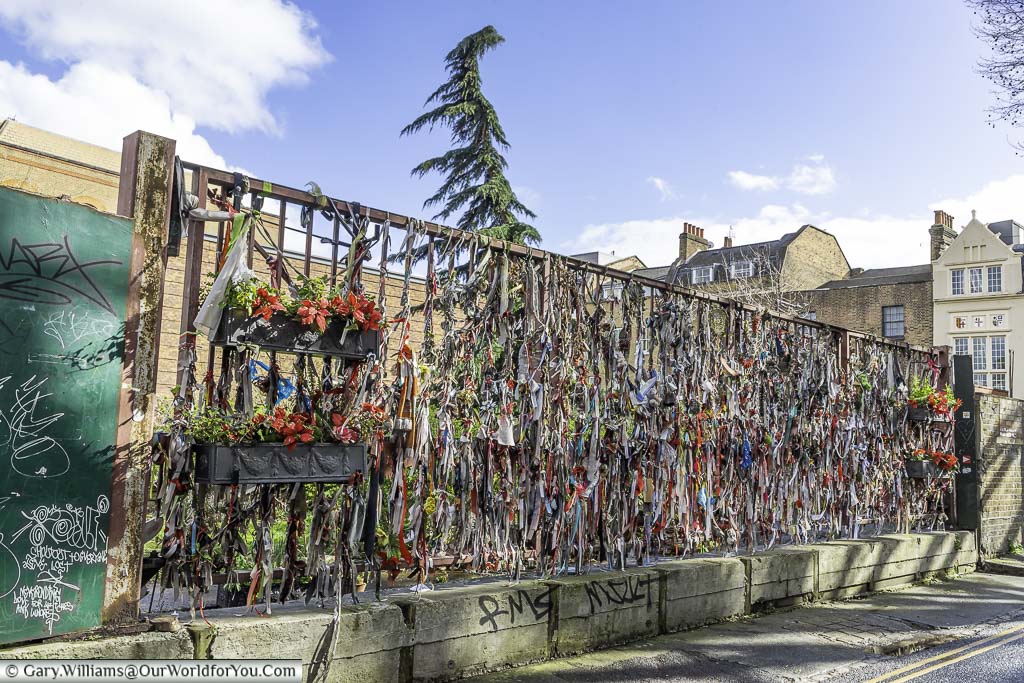 The railings of bankside's crossbones graveyard adorned with memorial ribbons for the souls remembered in the cemetery in London