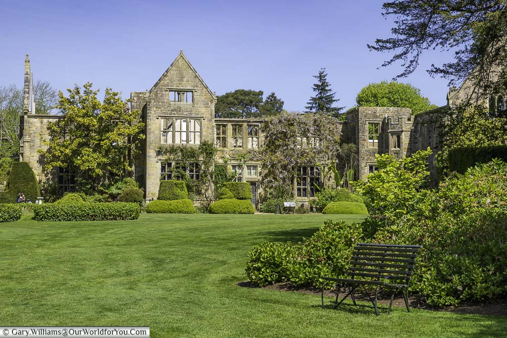 The partial ruins of nymans house in west sussex, as seen from the lawn in late spring