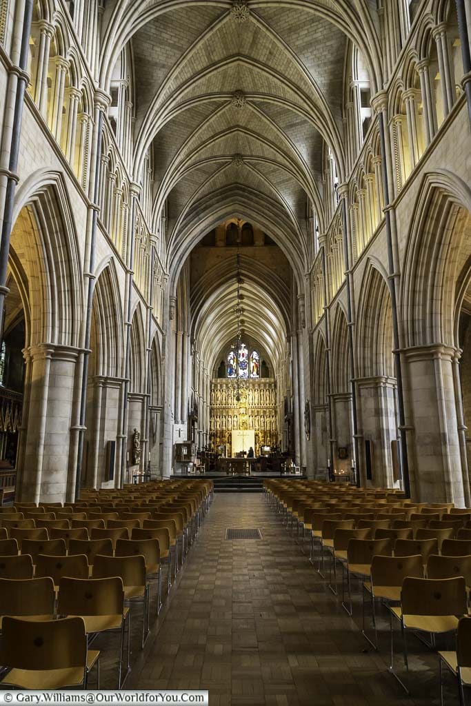 The nave of southwark cathedral on london's bankside with its tall stone vaulted ceiling