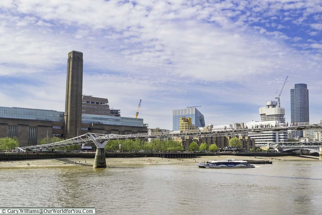 The tate modern on london's bankside as seen from the northside with the millennium bridge in the foreground
