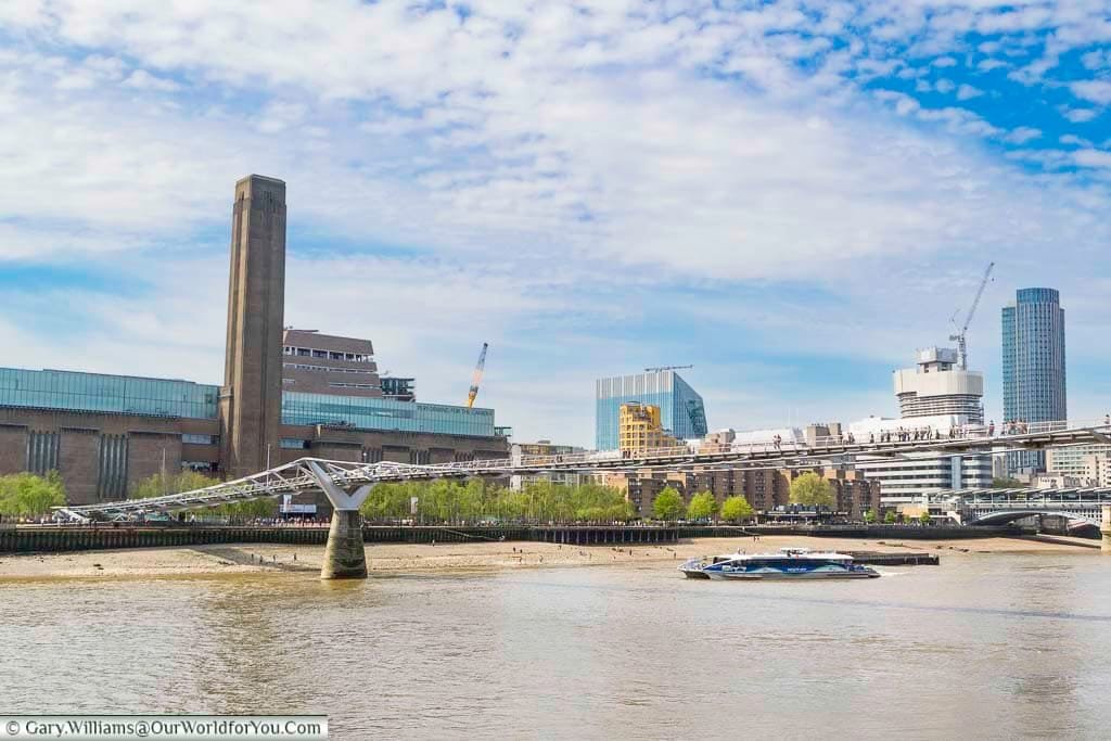 The tate modern on london's bankside as seen from the northside with the millennium bridge in the foreground