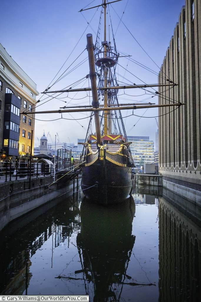 A full-size replica of the 16th-century golden hind ship in a wet dock in london's bankside