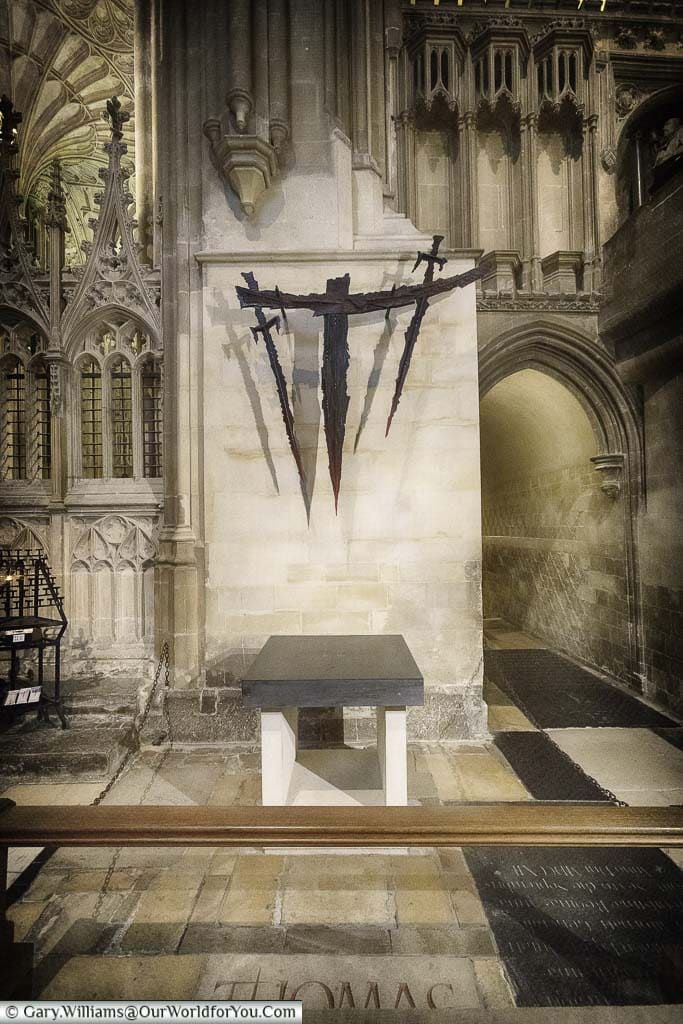 A modern art piece consisting of 3 medieval swords above the spot where Archbishop Thomas Becket was executed in Canterbury Cathedral.
