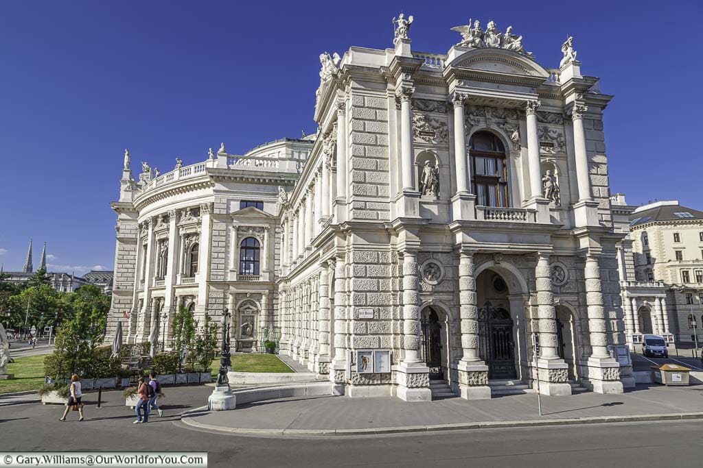 The side entrance of the Burgtheatre, the Austrian Nation theatre of a neo-classical design in a cream stone.
