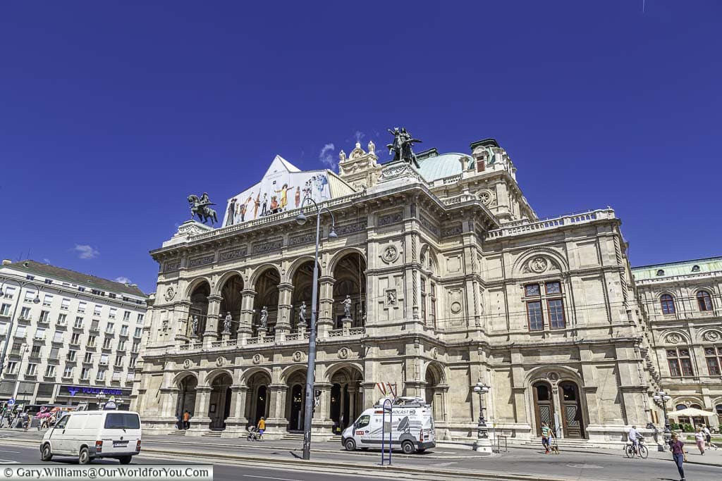 The front of the Vienna State Opera on the Opernring on a bright sunny day.