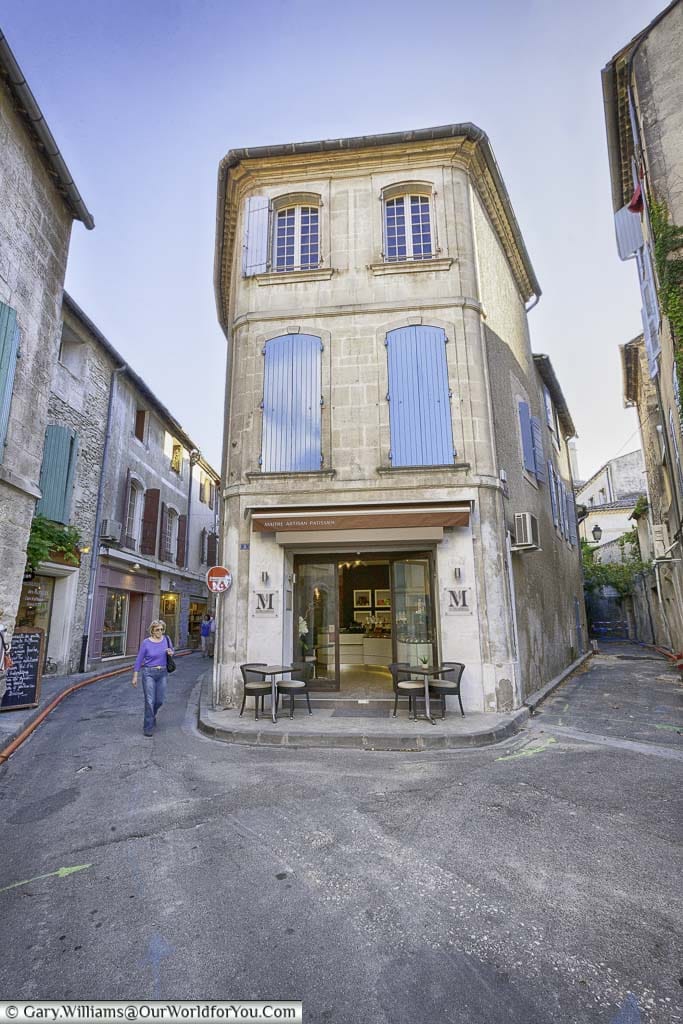 A Provencal cafe in the lower storey of a shuttered building in Saint-Rémy-de-Provence, France