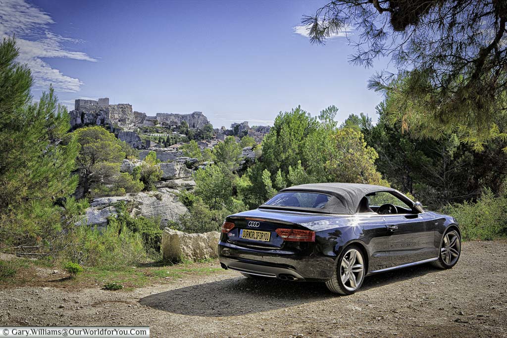 Our black Audi S5 convertible parked across the valley from the hillside town of Les Baux-de-Provence in the south of France