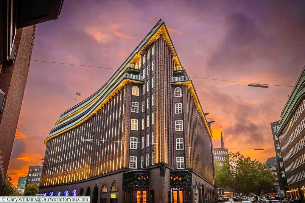 The sharp end of the Chilehaus office building at dusk under mauve to purple skies. This stylish 10-storey office block looks like a vision of the future as seen from the 1920s.