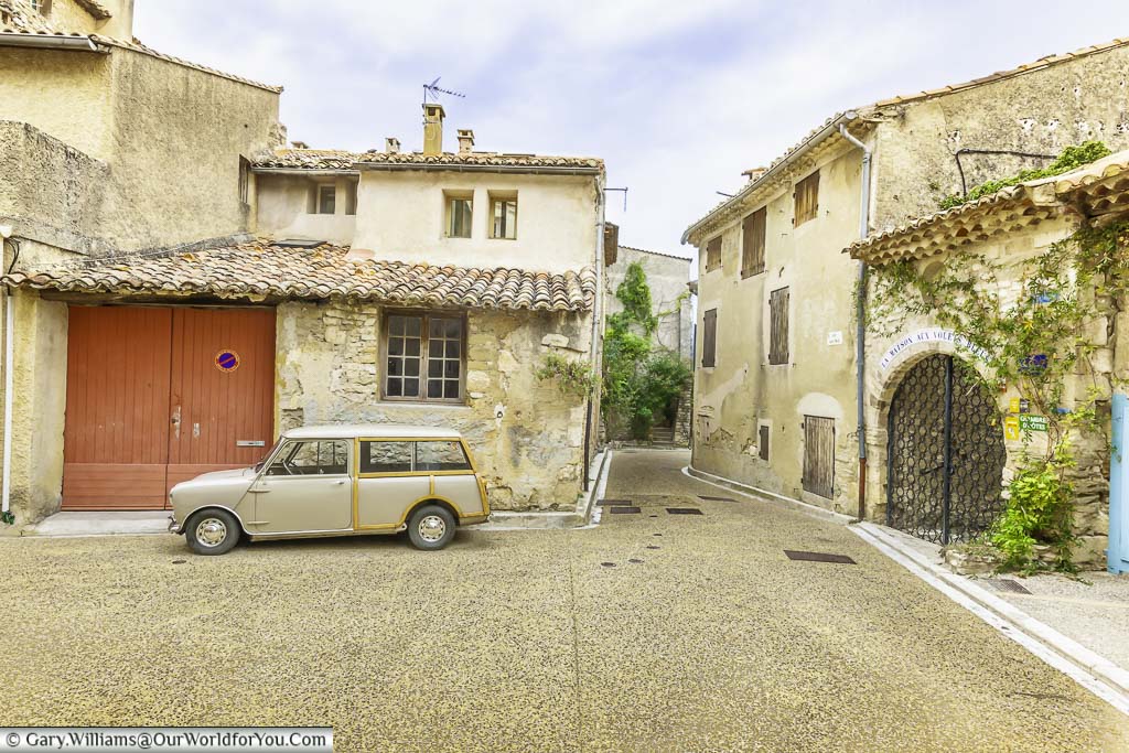 A Mini-Morris traveller parked up in the pretty Provencal town of Venasque in France