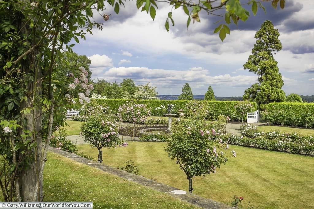 A view of the rose garden at emmett's to the countryside of the kent weald beyond