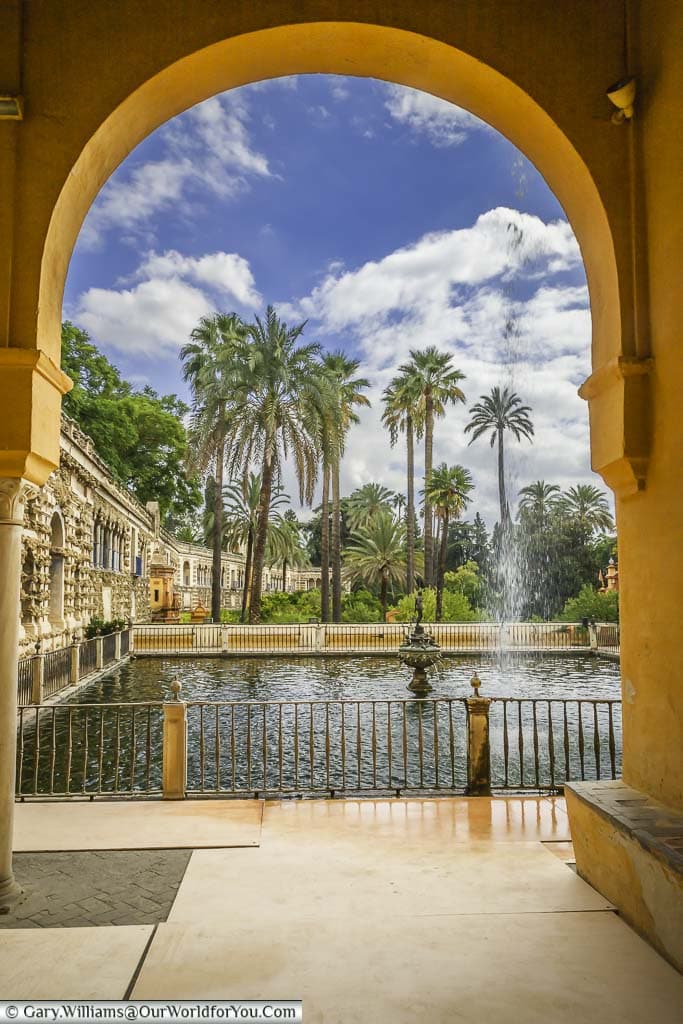 A view of the gardens through an archway in the Alcazar.