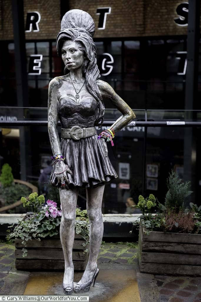A statue to the late music artist Amy Winehouse, complete with beehive hairstyle, in Camden Market.