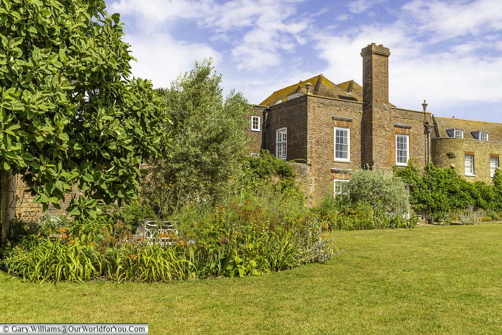 The cottage garden edged lawn in front of the national trust lamb house in rye, east sussex