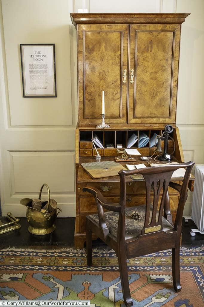 A ornate wooden bureau in the telephone room of lamb house in rye, east sussex