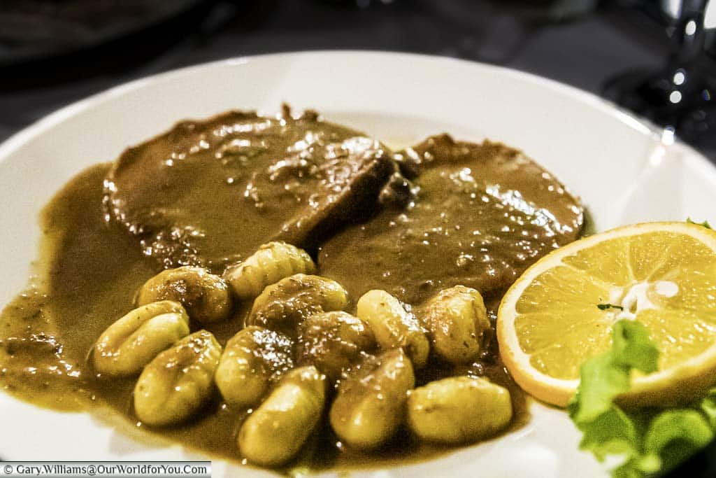Slices of beef in a dark rich sauce served with gnocchi