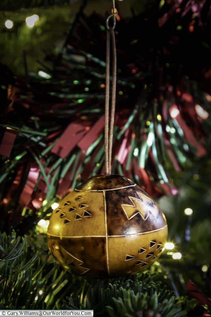 A carved wooded christmas bauble from Costa Rica hanging in our christmas tree