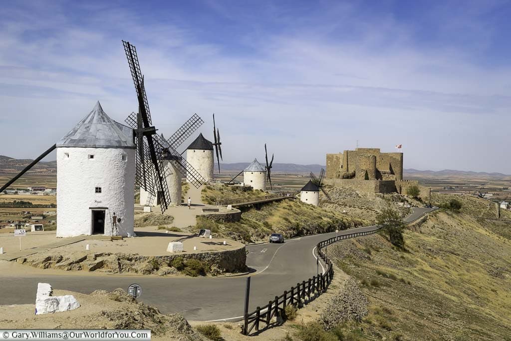 Looking down at the windmills of consuegra, la mancha, to the castle in the distance
