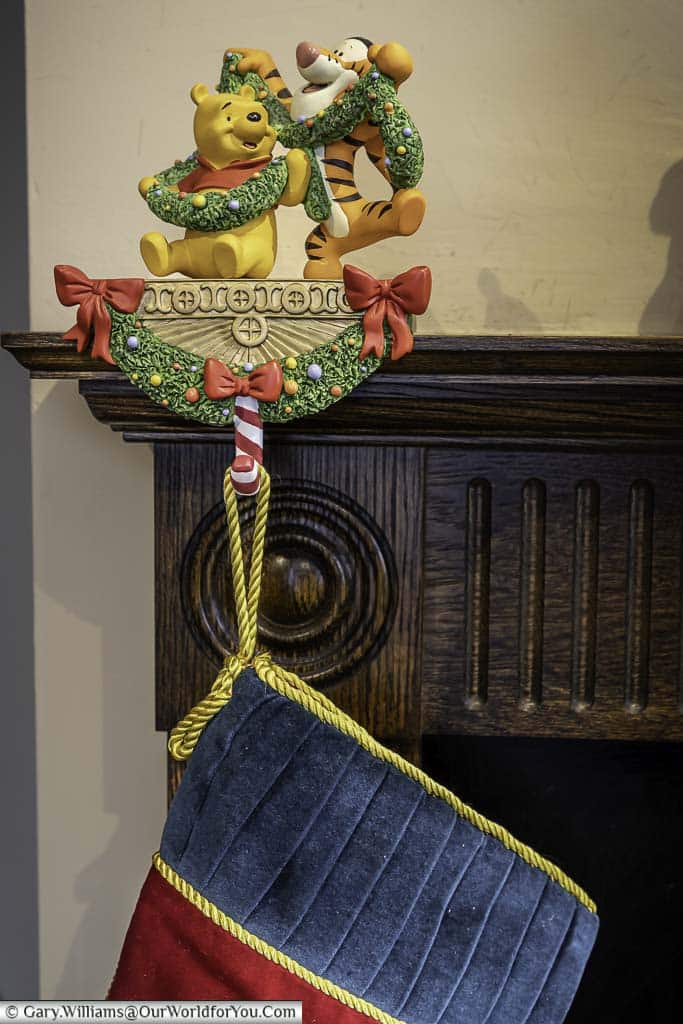 Our winnie the pooh and tigger disney stocking holder, with a stocking attached placed on our mantlepiece over our fireplace