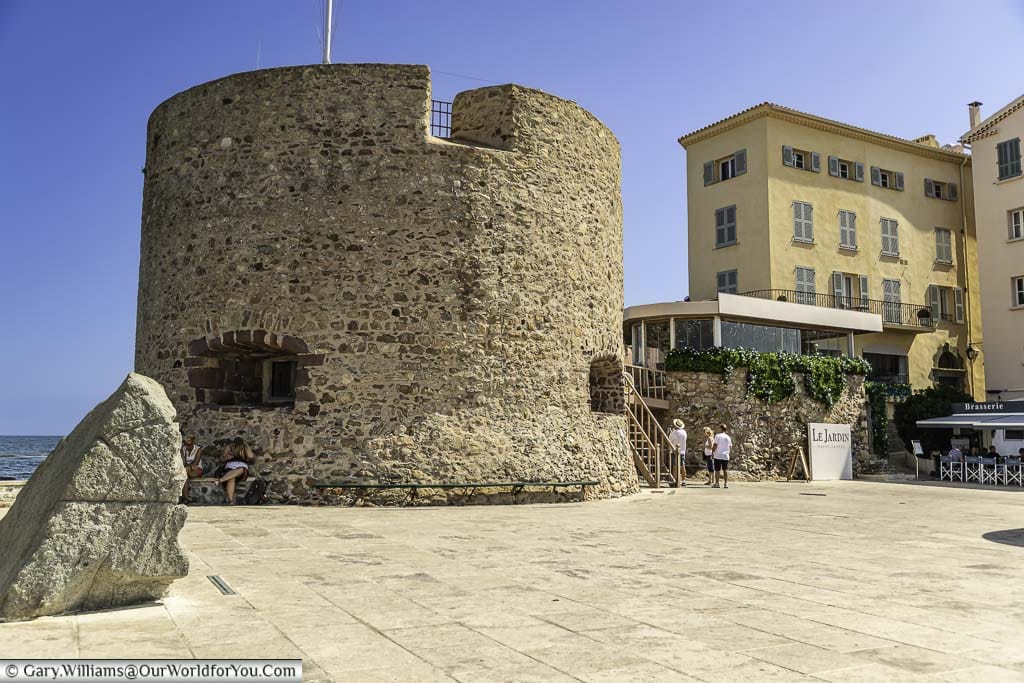 The medieval stone tower of a portalet tower on the edge of the harbour at saint tropez in the south of france