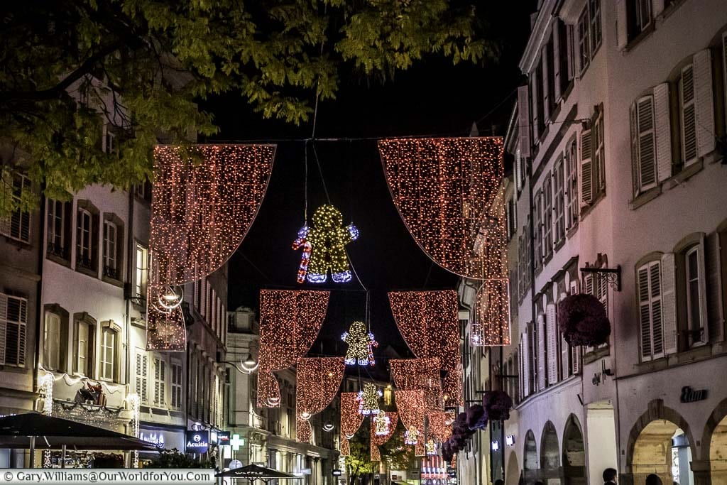 The street lights at Christmas along Place Gutenberg this year are gingerbread men holding candy canes between red curtains. They extend down the street as far as the eye can see.
