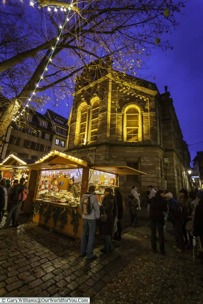 Groups of festive folks in the christmas market of the three magi on the streets historic strasbourg