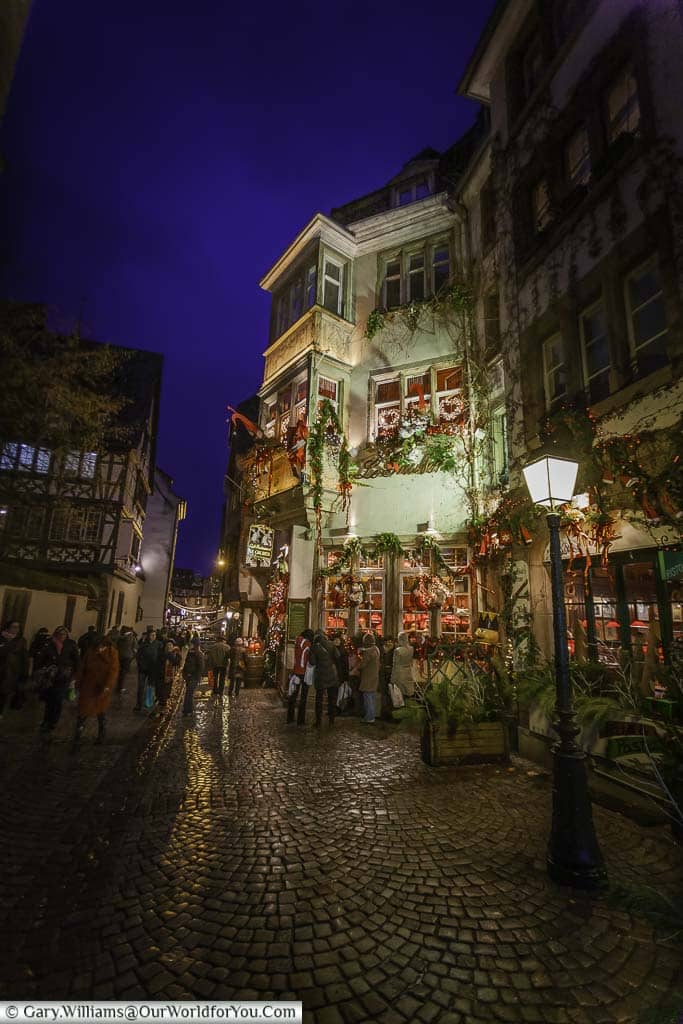 Looking up along rue du maroquin in strasbourg at night full of traditional half-timbered buildings that look extra special at christmas.