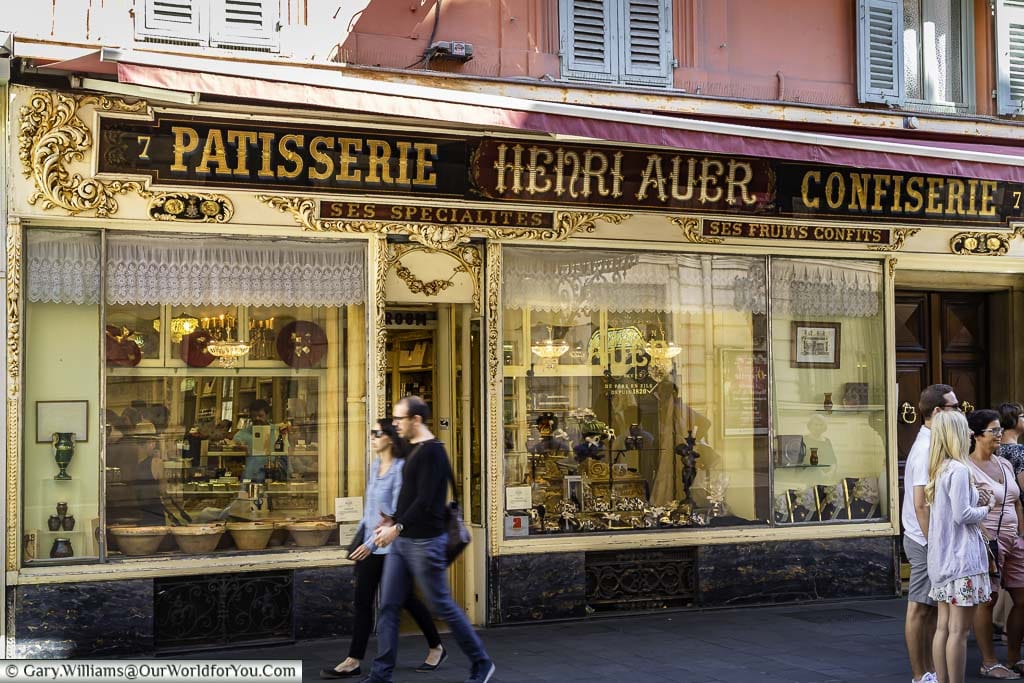 people walking in front of Confiserie ‘Henri Auer’ in nice in the south of france