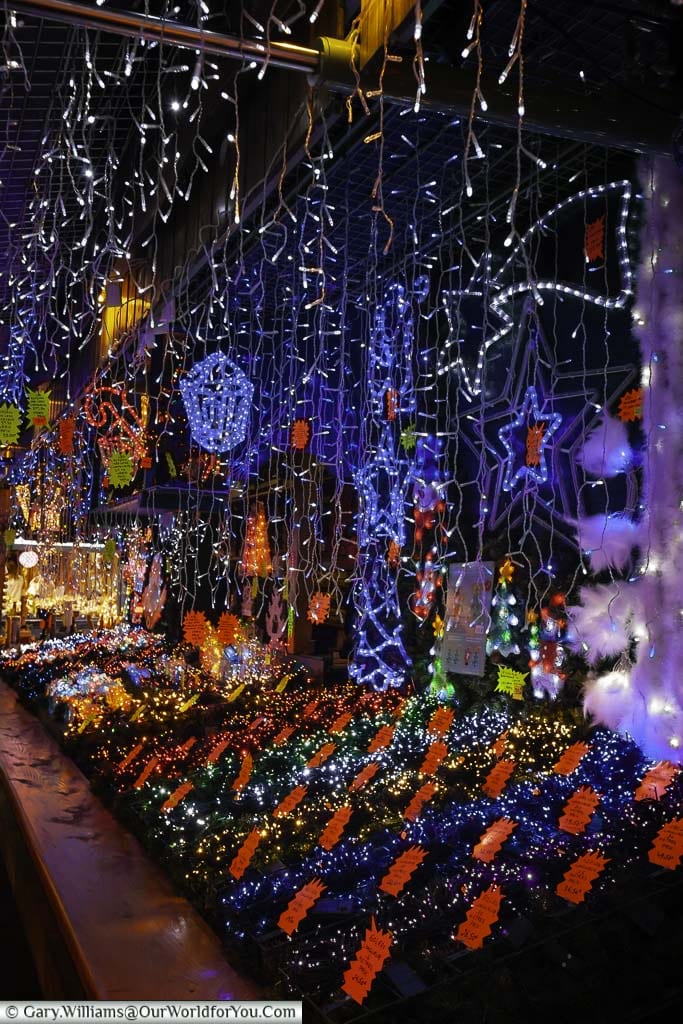a stall on strasbourg's christmas markets selling christmas lights and decorations