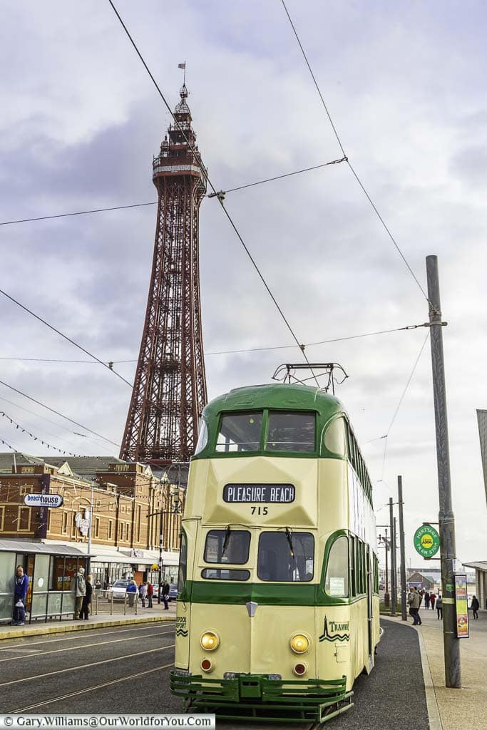 A classic tram on Blackpool's seafront with the Blackpool Tower in the background