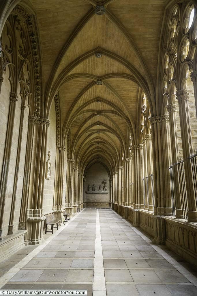 Looking along the sandstone columns of pamplona cathedral's cloisters