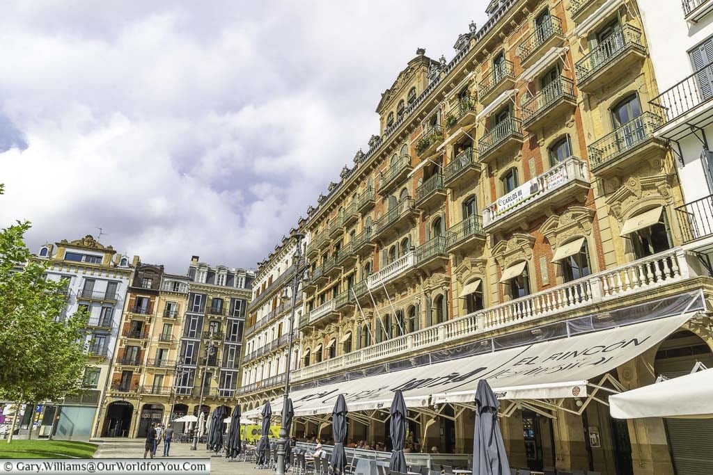 One edge of plaza del castillo lined with tall baroque buildings in pamplona, spain