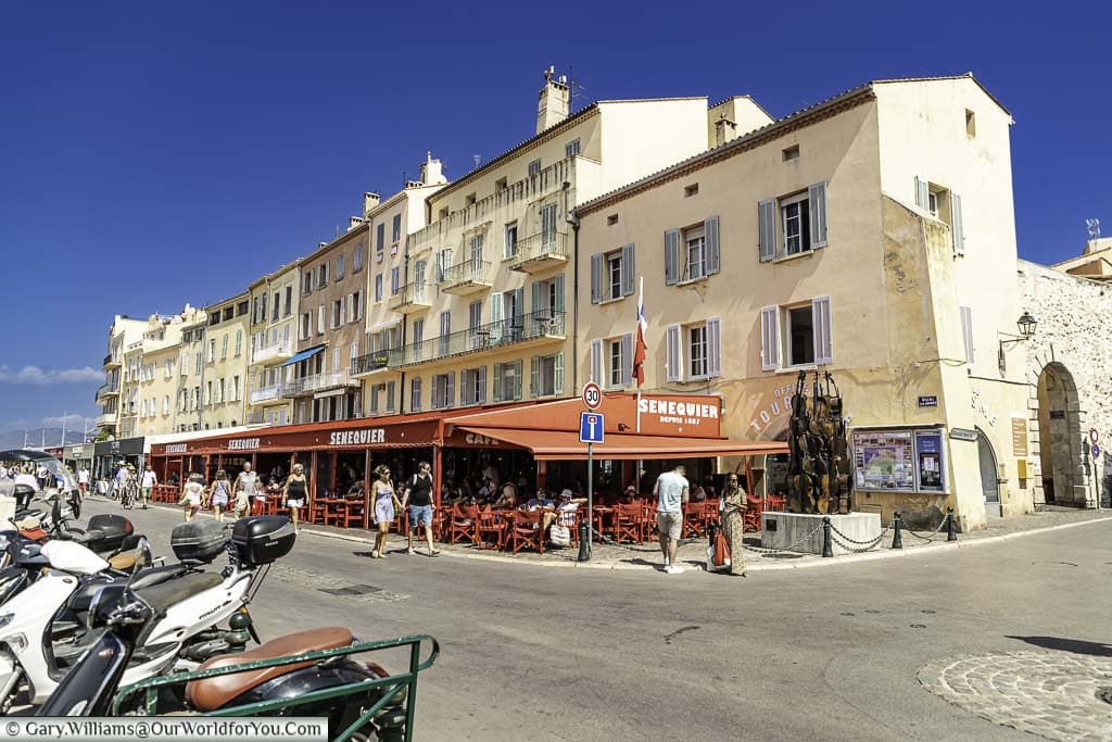 the pastel coloured shops, cafes and restaurants on quai jean jaures in saint tropez in the south of france