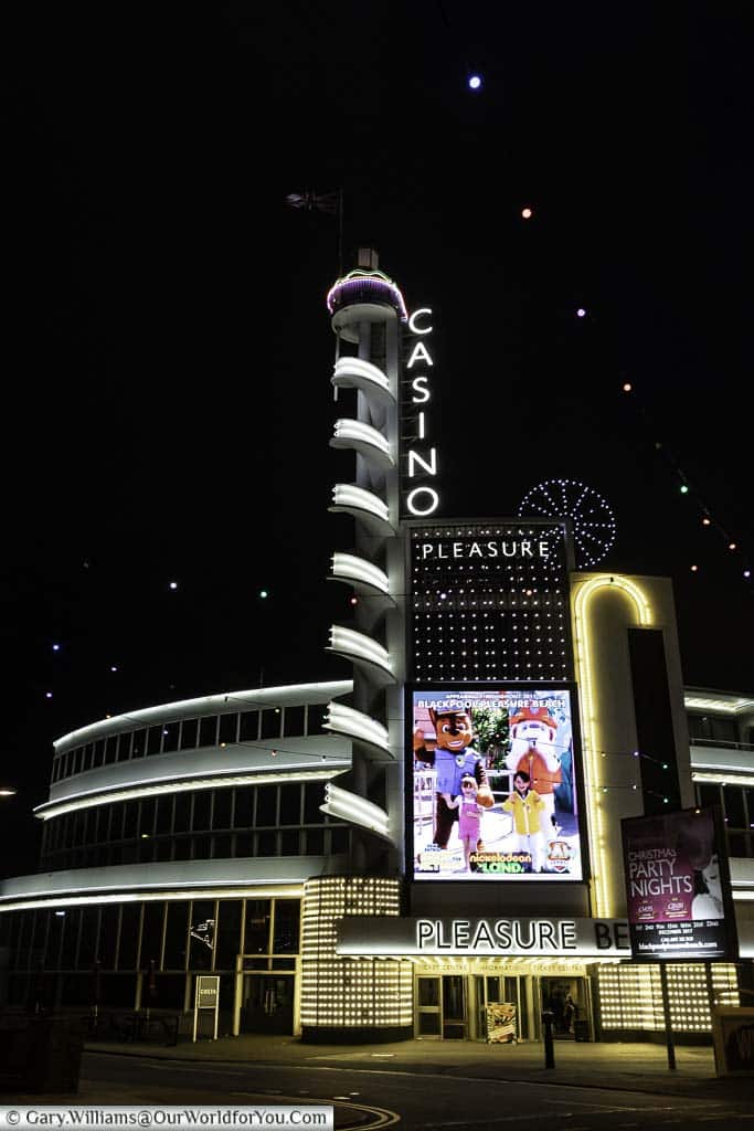 The Art Deco-styled illuminated entrance to the Pleasure Beach featuring a tower with a neon casino sign.