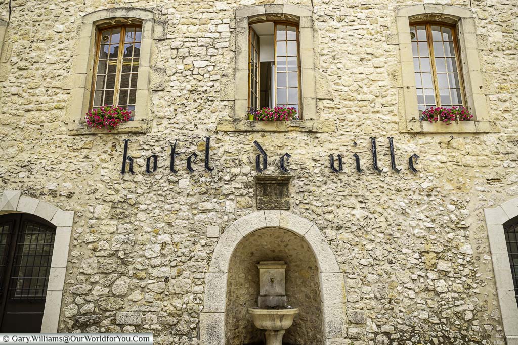 A close-up of the stone facade of the hotel de ville in the heart of the village of tourrettes sur loup in provence, france