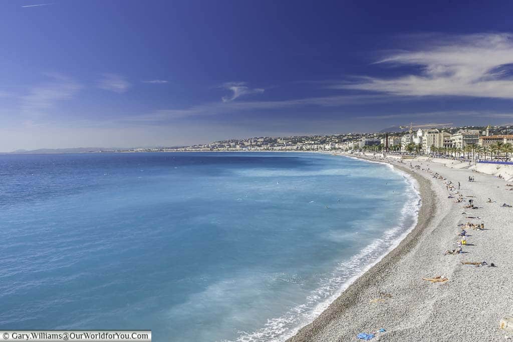The beach and azure blue water of the Nice cosatline on the Cote d'Azur, France