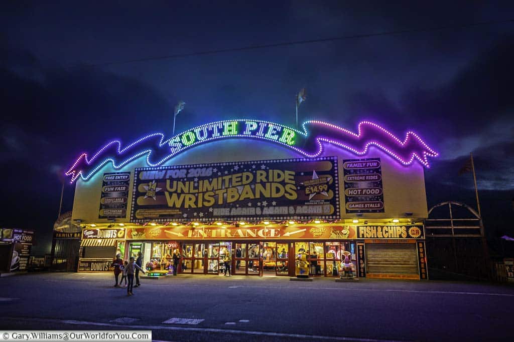 The illuminated entrance to Blackpool's South Pier after dark.