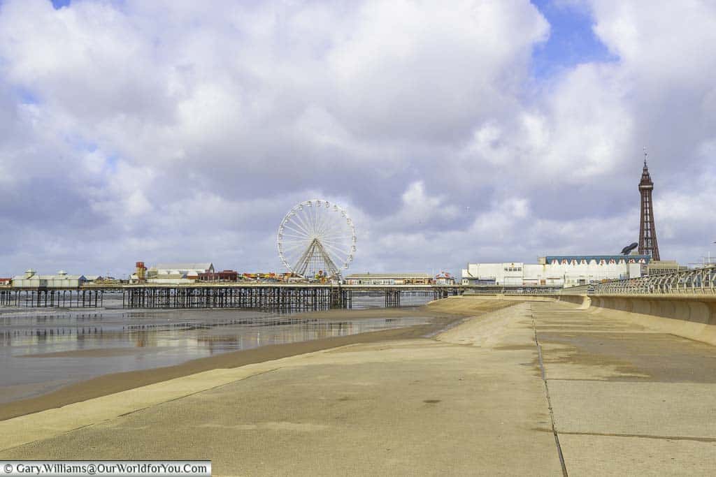 The view along the sea wall towards Blackpool's South pier, with Blackpool Tower in the distance.