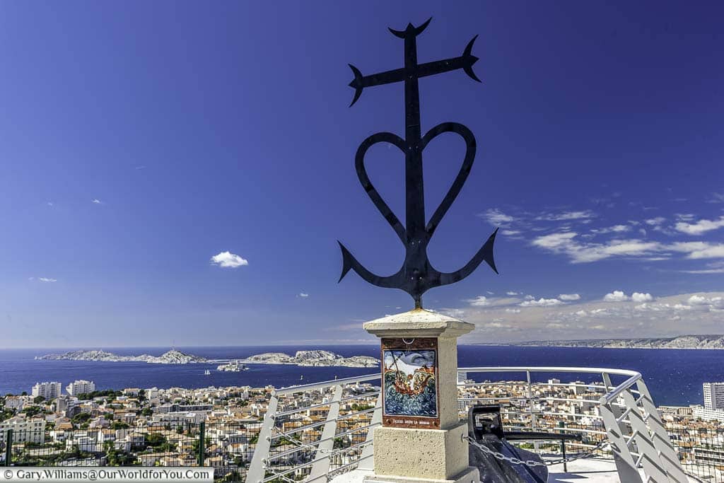 A mariners cross at the viewpoint of the Basilique Notre-Dame de la Garde overlooking the city of Marseille.