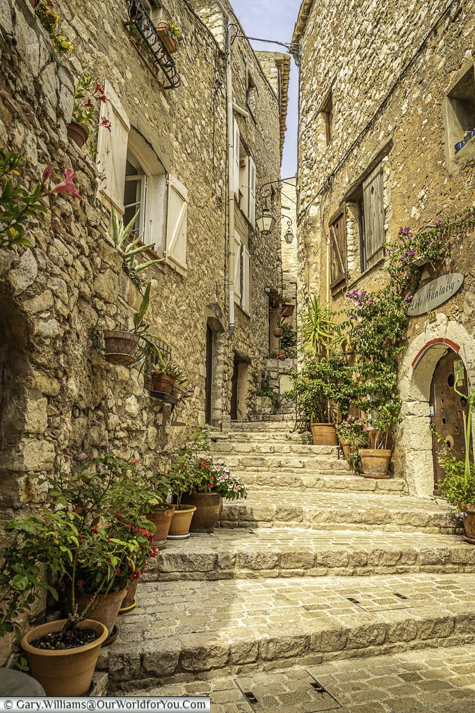 Steps leading to a small cobbled lane, lined with terracotta pots in the village of tourrettes sur loup in provence, france