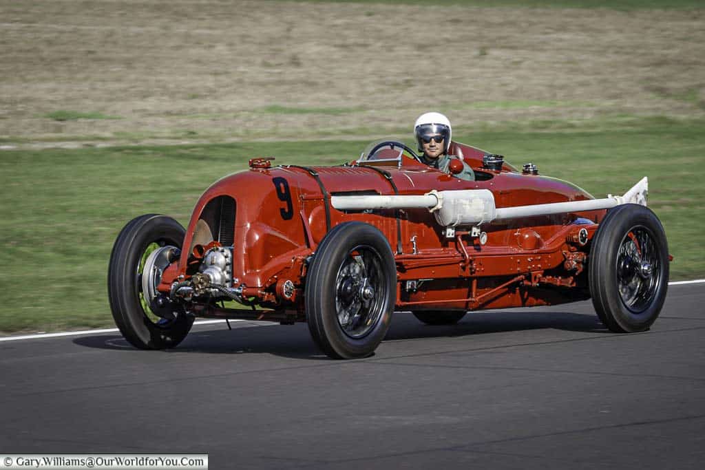 the bright red 1929 bentley 'birkin' single-seater hisotric racing car at the goodwood revival meeting