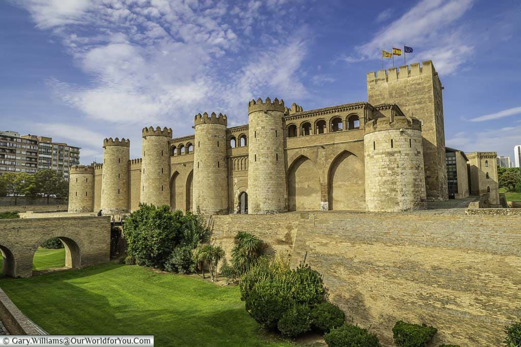 the mudéjar exterior of the aljafería palace as seen from across the moat in zaragoza, spain
