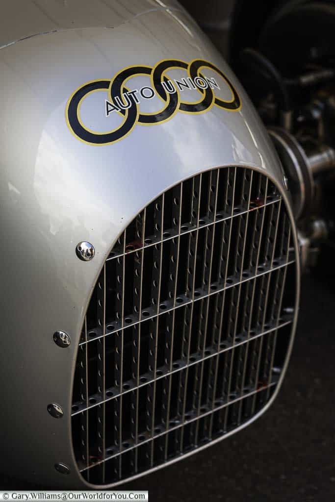 a close-up of the nose of a 1936 auto union type c parked in the paddock of the goodwood festival of speed