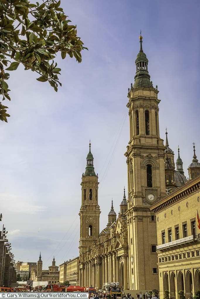 a portrait view of the towers of cathedral-basilica of our lady of the pillar from the plaza del pilar in zaragoza, spain