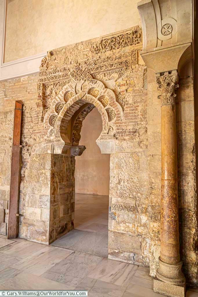 the entrance arch to the mosque within the aljafería palace in zaragoza, spain