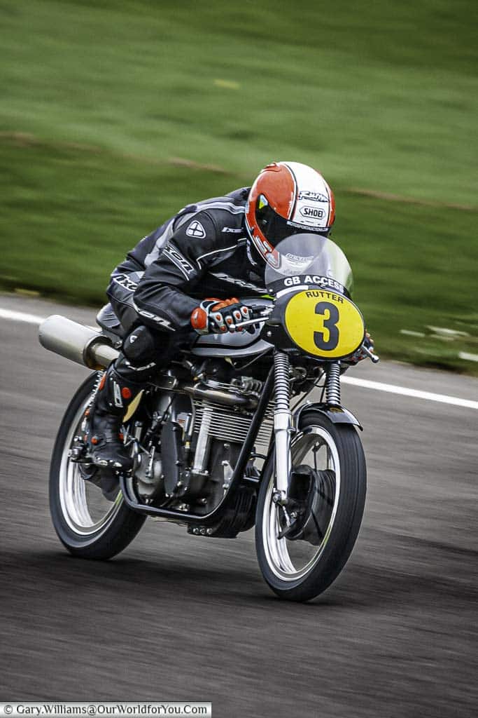 michael rutter, motorcycle racer, riding a 1960 norton manx 30m at speed at the goodwood revival meeting